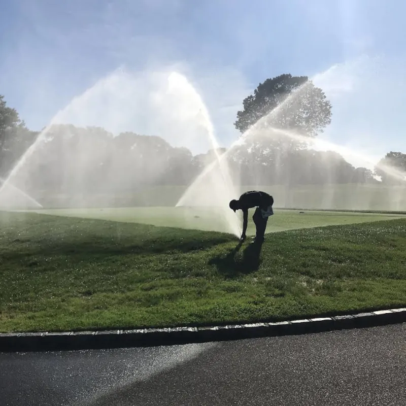 A man adjusting sprinklers